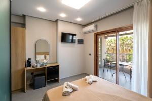 a room with a bed and a table with a mirror at Villa N&D in Ierissos