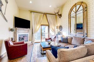 a living room with a couch and a fireplace at The Silver Saddle in Ketchum