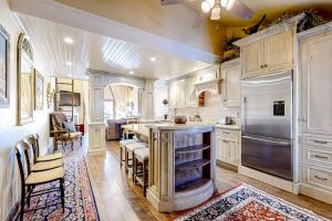 a kitchen with white cabinets and a large island at The Silver Saddle in Ketchum