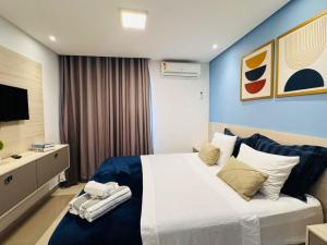 a bedroom with a large bed and a television at Hospede-se com conforto em Capim Macio in Natal