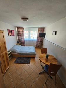 a bedroom with a bed and a table in it at Margaretka in Łeba