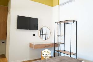 a living room with a tv on a wall at The Core Lezhe in Lezhë