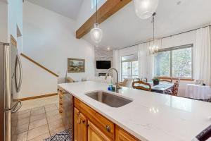 a kitchen with a sink and a dining room at Blue River Grove in Silverthorne