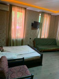 a bedroom with two beds and a tv on the wall at Borjomi Paradise in Borjomi