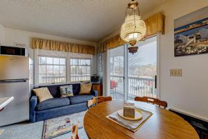 a living room with a table and a blue couch at Wellington Manor 240 in Wells