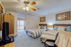a bedroom with two beds and a ceiling fan at Wellington Manor 240 in Wells +72 photos