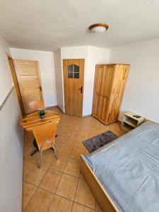 a bedroom with a bed and a desk and a chair at Margaretka in Łeba