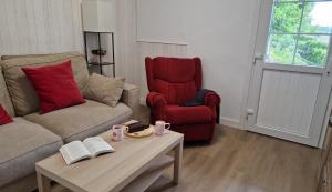 a living room with a couch and a chair and a coffee table at La casina de Pili in Villaviciosa