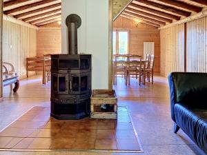 a wood stove in a living room with a table at Apartment Chalet Anthamatten-2 by Interhome in Champéry