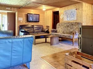 a living room with leather furniture and a flat screen tv at Apartment Chalet Anthamatten-2 by Interhome in Champéry +22 photos