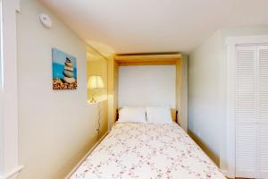 a small bedroom with a bed and a window at Shorelands 44-2 in Kennebunk +38 photos