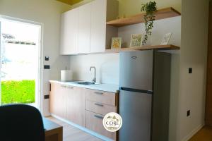 a kitchen with white cabinets and a refrigerator at The Core Lezhe in Lezhë +20 photos