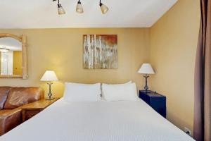 a bedroom with a large bed and a couch at River Mountain Lodge #W101 in Breckenridge +50 photos