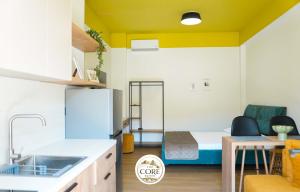 a small room with a bed and a kitchen at The Core Lezhe in Lezhë