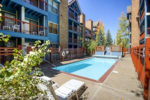 a swimming pool in front of a apartment building at River Mountain Lodge #W101 in Breckenridge