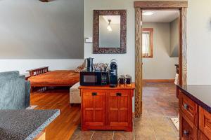a living room with a microwave on a table at The Loft at Fort Defiance in Barnard