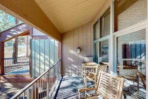 a porch with a bench and a table on it at Tamarron 765 in Durango