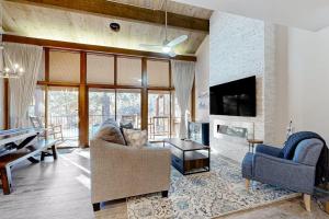 a living room with a couch and a fireplace at Tamarron 765 in Durango