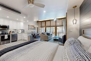 a large bedroom with a large bed and a kitchen at Tamarron 765 in Durango +72 photos