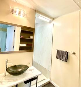 a bathroom with a sink and a shower at Cedar House Ocean View & Access in Roberts Creek +19 photos