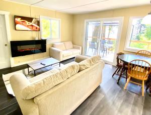 a living room with a couch and a table at Cedar House Ocean View & Access in Roberts Creek