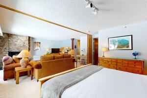 a bedroom with a large bed and a living room at Lichenhearth # 4 in Snowmass Village +52 photos