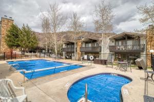 a swimming pool in front of a building at Lichenhearth # 4 in Snowmass Village