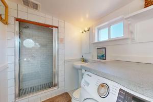 a bathroom with a washing machine and a window at Fisherman in Newburyport +46 photos