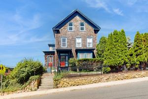a brick house with a fence on a street at Longview House in Gloucester