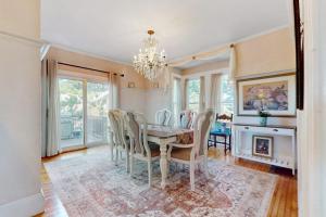 a dining room with a table and chairs and a fireplace at Longview House in Gloucester