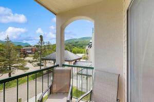 two chairs sitting on a balcony with a view at South Peak Studio at Rivergreen in Lincoln