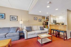 a living room with a couch and a table at South Peak Studio at Rivergreen in Lincoln