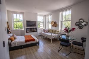a bedroom with a bed and a living room at Les Lofts Ste-Anne in Quebec City