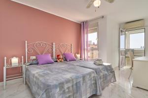 a bedroom with a bed with a teddy bear on it at Mirador del Mar in Torrox Costa +24 photos
