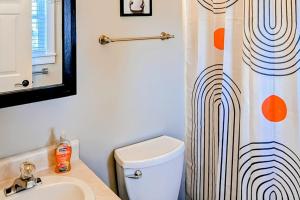 a bathroom with a toilet and a shower curtain at Okemo Era in Ludlow