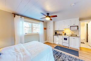 a bedroom with a bed and a ceiling fan at Sweet Retreat in Ludlow +24 photos