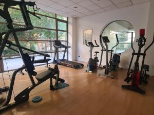a gym with several tread machines and a mirror at Manuel Montt Spot by AndesPlus in Santiago
