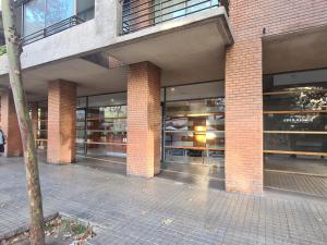 a brick building with large windows in a building at Manuel Montt Spot by AndesPlus in Santiago