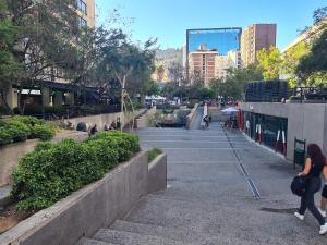a group of people walking down some stairs in a city at Manuel Montt Spot by AndesPlus in Santiago +2 photos