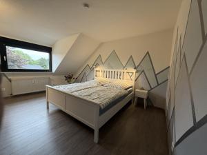 a bedroom with a bed with a mural on the wall at Niederrhein Suite Kerken in Kerken