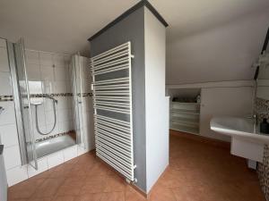 a bathroom with a shower and a toilet and a sink at Niederrhein Suite Kerken in Kerken +24 photos