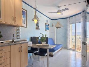 a kitchen with a table and chairs in a room at Apartment Club Nautic-17 by Interhome in Empuriabrava