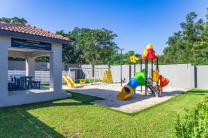 a park with a playground with a slide at Royalty Suites in Chartwell Sandton in Chartwell