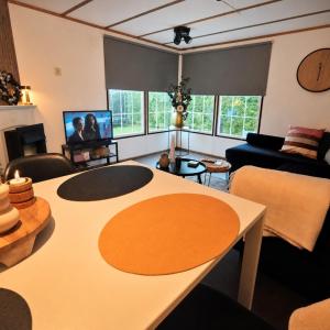 a living room with a table and a couch at Vienna in Dronrijp