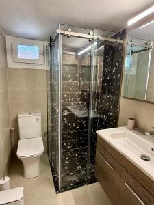 a bathroom with a shower with a toilet and a sink at Mosaic House in Sami +9 photos