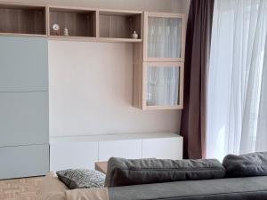 a living room with a couch and a window at Ferienwohnung Eulenwinkel in Pappenheim
