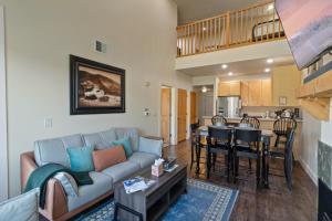 a living room with a couch and a kitchen at Crestview Condominiums by All Seasons Resort Lodging in Park City