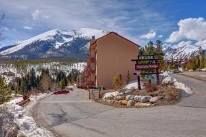 a building on the side of a road with a snow covered mountain at Buffalo Ridge C302 in Silverthorne