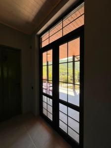 a room with a large glass door with a balcony at Malina Utsera in Oni