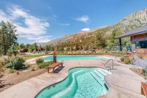 a swimming pool with a bench and a mountain at Million Dollar View- 419 in Durango